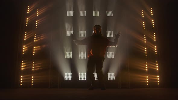 Professional Young Hip-hop Dancer, Dancing in Dark Studio in the Green and Yellow Fog. Hip Hop alt