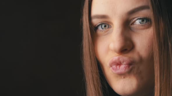 Face of a Beautiful Young Woman Sending a Kiss alt