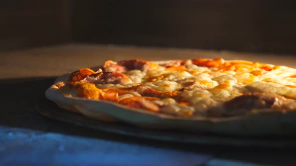 Young Cook Taking Out Tasty Pepperoni Pizza From Oven with a Shovel at Cuisine alt