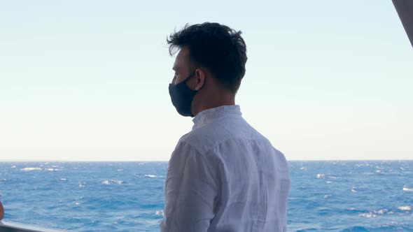Man in Mask Enjoys Holiday Looking at Sea From Cruise Boat at COVID19 Pandemic