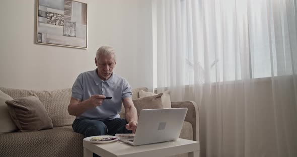 Senior Man Making Online Purchases alt