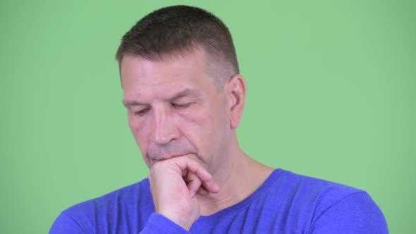 Face of Stressed Macho Mature Man Thinking and Looking Down alt