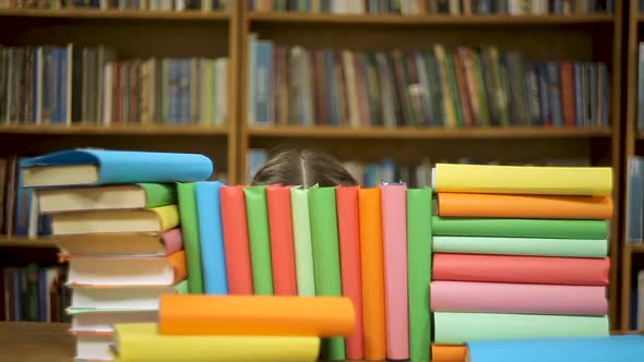 Girl Hugs Books in the Library