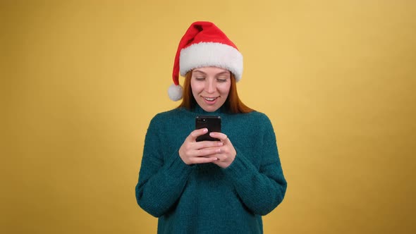 Shocked Surprised Woman in Green Cozy Sweater Santa Christmas Hat