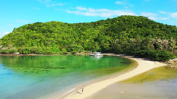Vivid colors of beautiful bay with calm green water washing white sandy beach on tropical island wit alt