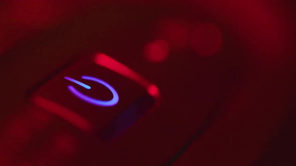 A Man Presses the Computer's Power Button and the Computer Starts. Then the Man Shuts Down the