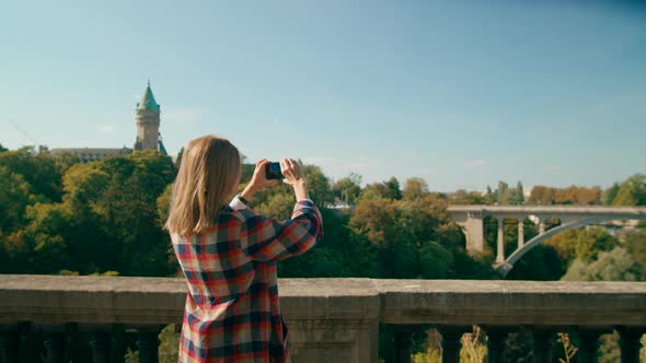 European Woman Takes Photo or Video By Mobile Smart Phone in Luxembourg City