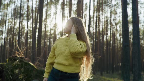 Beautiful Girl in the Forest with Long Hair Smiling