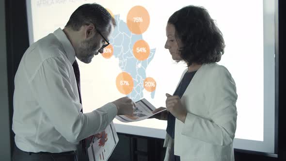 Businesswoman Showing Map and Explaining Data To Boss alt