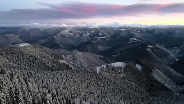 Drone Flying Above Mountain Valley at Sunrise