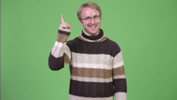 Studio Shot of Happy Handsome Man Pointing Up alt