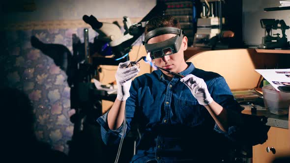 Silver Ring Is Getting Burnt By the Craftsman. Jeweler Working Jewelry alt