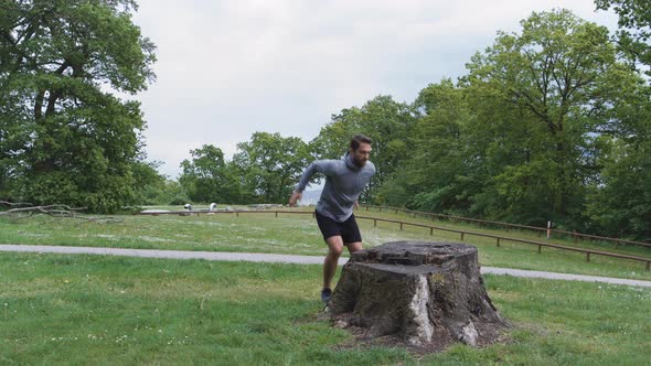 Athlete Jumping Up And Down Onto Tree Stump