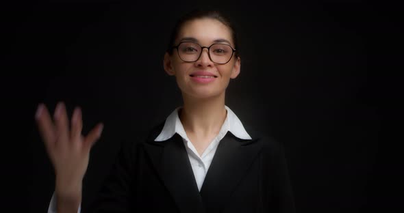 Asian Woman in Glasses Smiling and Shows Four Fingers with Her Right Hand