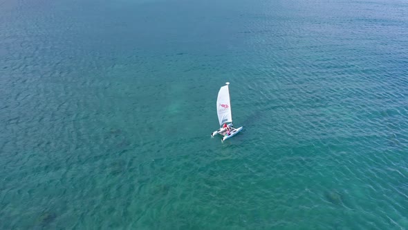 Aerial top down shot of Catamaran Sailing boat cruising on Caribbean Sea near PLAYA NUEVA ROMANA in alt