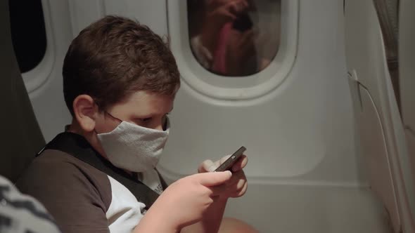 Boy in Mask on Airplane