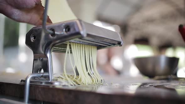 Chef's Hands Use a Pasta Cutting Machine