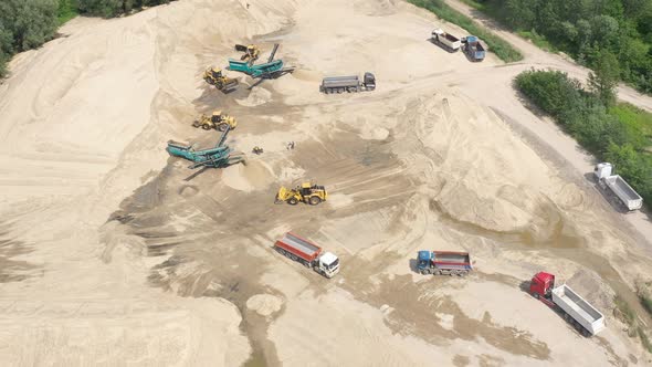 Mining conveyor at sand quarry. Aerial view of mining machinery. Mining industry alt