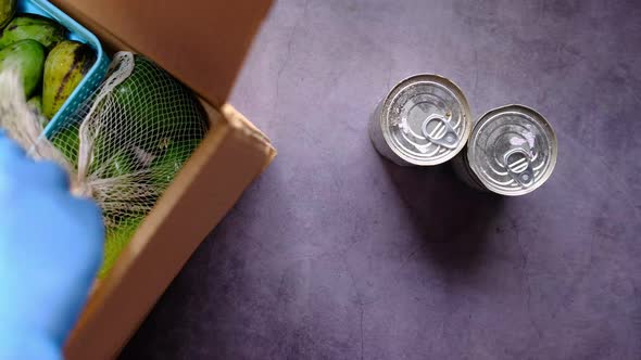  Door Delivery of Goods. Order Picker Packing Foods in a Cardboard Boxes.