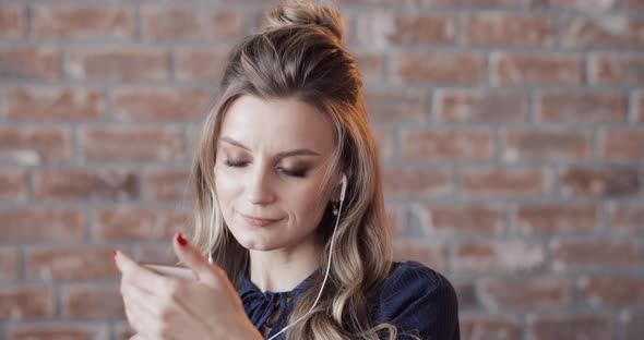 Happy Beautiful Blonde Woman Talking To Her Friend on the Phone and Kissing It in the End