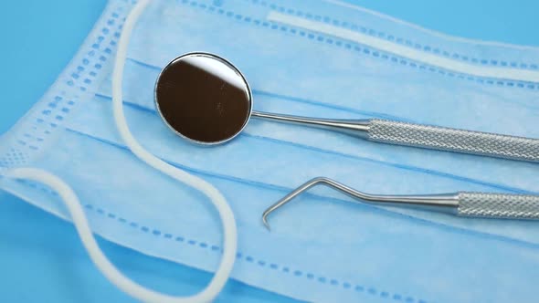 Dental Devices Lie on Blue Face Mask