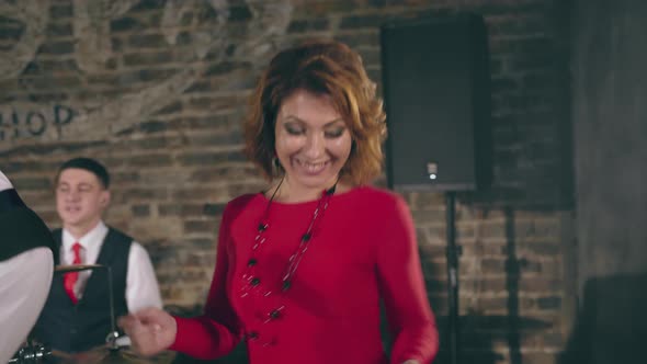 Beautiful Girl Plays Synthesizer As Part of Musical Group alt