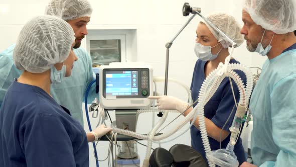 Surgical Nurse Points Her Finger on the Monitor alt