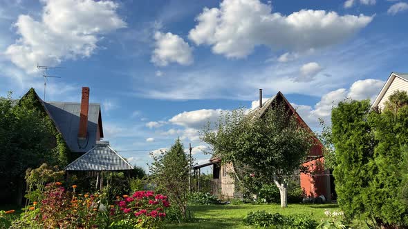 Clouds moving on blue sky above houses in village