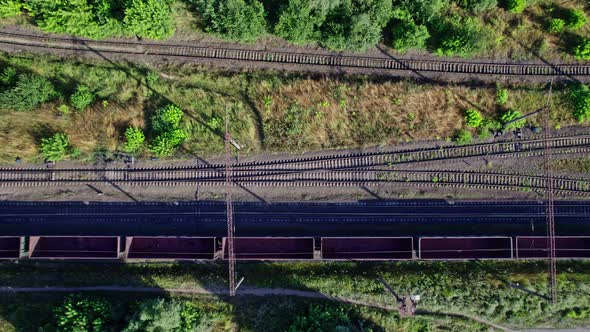 Freight Long Train Carries with Cargo Carriages in a Village alt