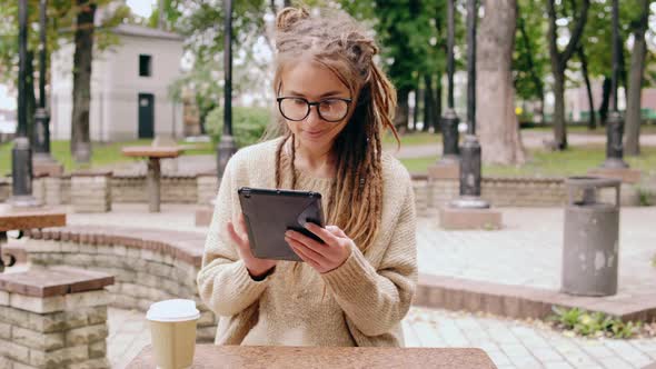 Smiling Hipster Girl Resting in Park alt