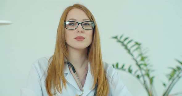 Portrait Of Smiling Female Doctor Wearing White Coat With Stethoscope In Hospital Office alt