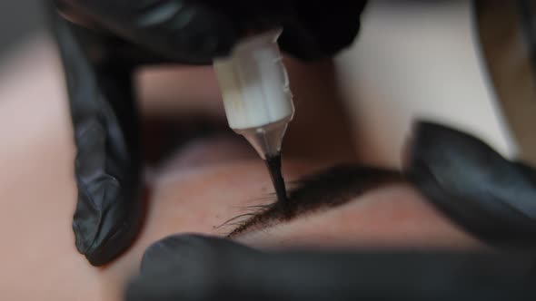 Microblading Pen Injecting Ink in Facial Skin Closeup alt