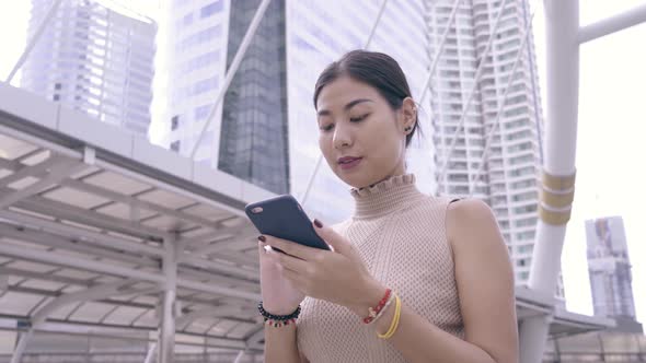 Happy Young Woman Using Smartphone