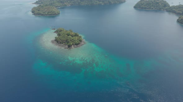 Aerial: flying over tropical island Banda Islands Maluku Indonesia alt