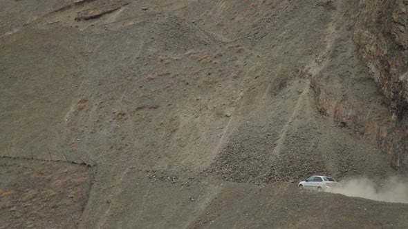 Aerial View of Car Driving Along the Mountain Chain