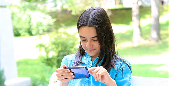 Girl Playing on Smart Phone alt