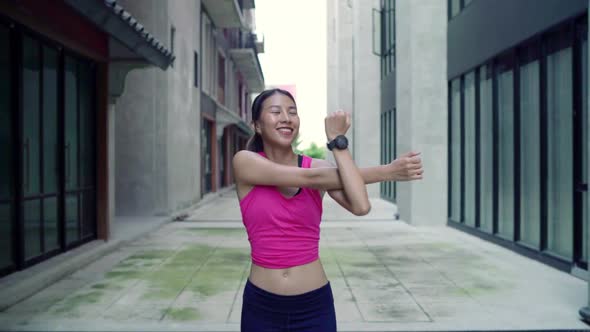young Asian women legs and stretching her arms to ready for running on street in urban city park. alt