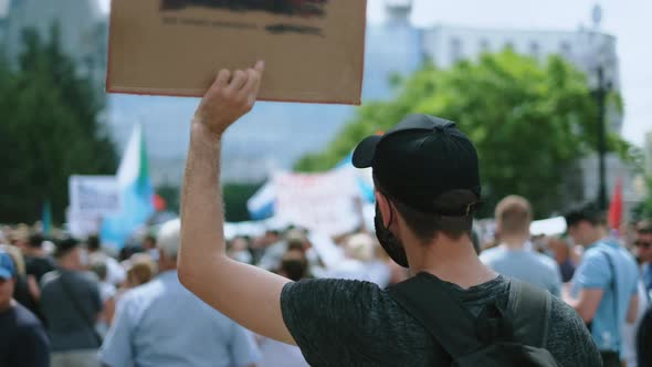 Protesting Activists with Placard Banners on Political Rally During Coronavirus alt