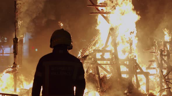 Fireman Controls the Bonfire of Las Fallas Festival in Spain alt