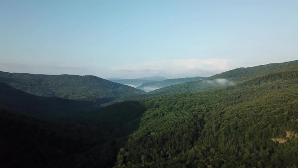 Aerial Landscape View of Caucasus Mountain at Sunny Morning with Fog. alt