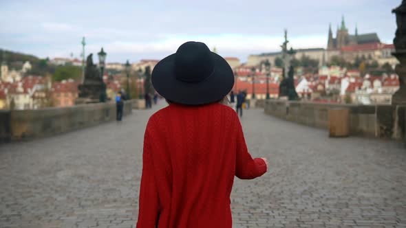 Girl Wearing Hat and Red Jacket Enjoying the City During Her Vacation alt