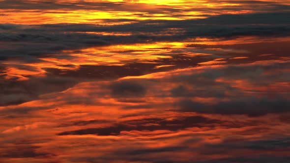 Intense, colorful sunset clouds. Unique high altitude, above-the-clouds footage. 