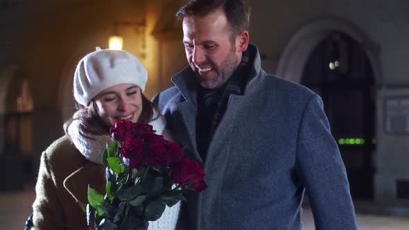 Loving couple flirting in the city street alt