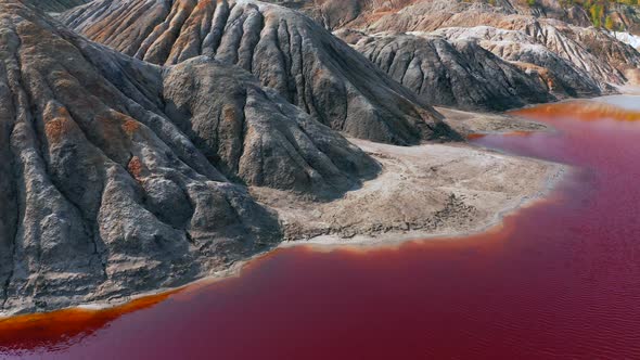 Aerial View of a Landscape Similar To the Planet Mars with Red Hills and Rivers with Red Water alt