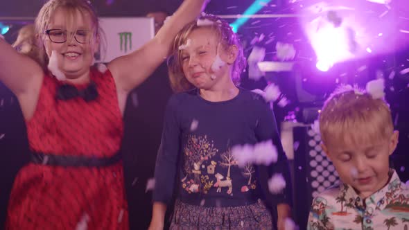 Kids Jump and Dance Whilst a Foam Machine Pumps Out Foam and Bubbles at Children's Party/Disco alt