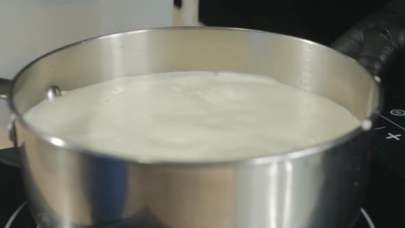 Milk Cream Begins to Simmer in a Stainless Steel Saucepan