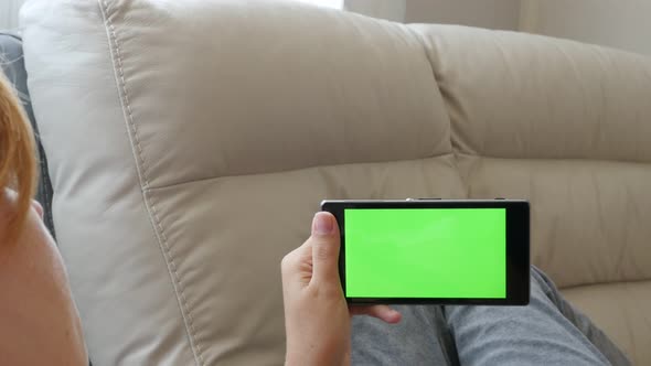 Relaxing at home female using smart phone with touch green screen display 4K 2160p 30fps UHD video - alt