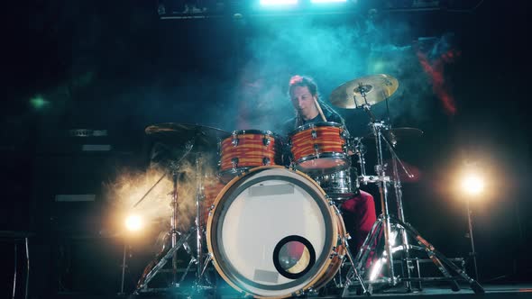 A Man Is Rehearsing His Drumming Skills in a Studio. Drum Kit, Drummer Playing on Drums alt