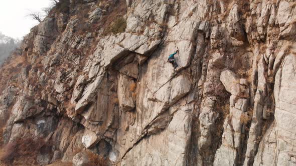 Man Athlette Climbing on the High Rock alt