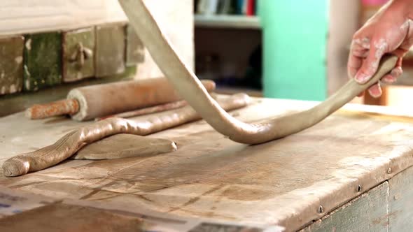 Male potter molding clay alt